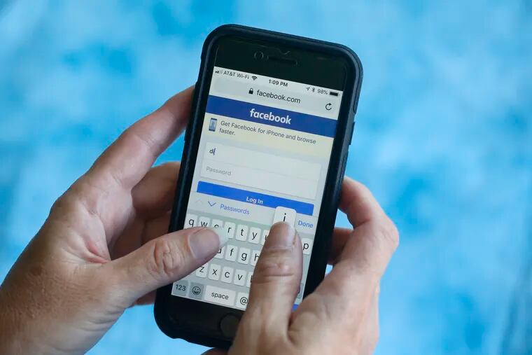 In this Aug. 21, 2018, file photo a Facebook start page is shown on a smartphone in Surfside, Fla.