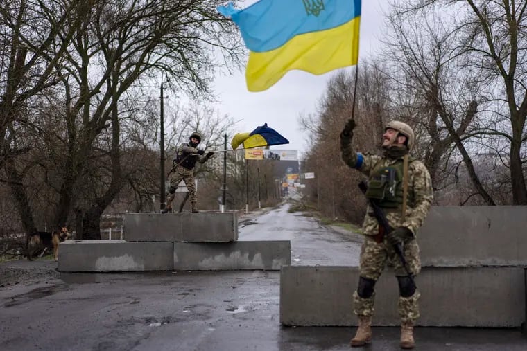 Ukrainian soldiers celebrating at a check point in Bucha, on the outskirts of Kyiv, Ukraine, on Sunday.