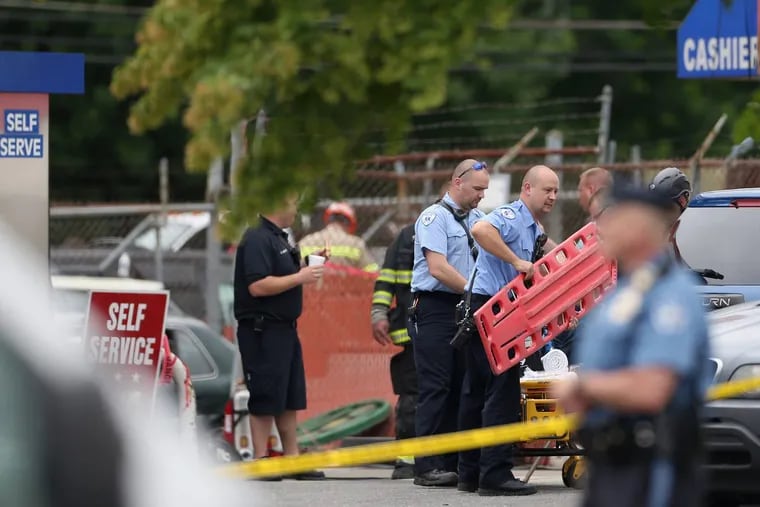 Emergency responders work to recover the body of a man trapped in an underground chamber after an explosion Tuesday rocked a gas station in Bensalem, Pa., on Wednesday, June 13, 2018. The explosion also left one person in critical condition.