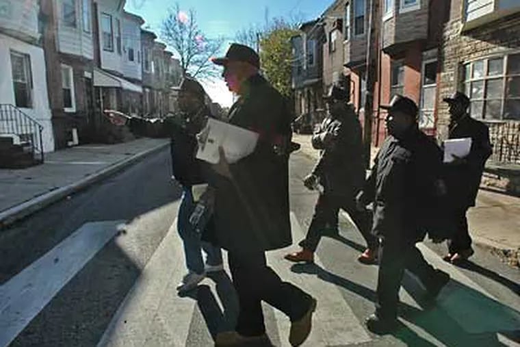 Members of the 10,000 Men Call To Action spread out and knock on doors near Wharton Square Park. (Jonathan Wilson/Inquirer)