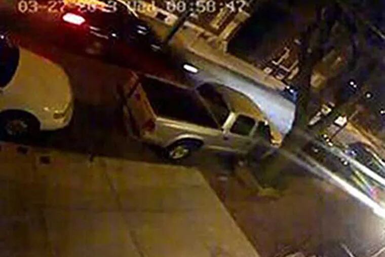 Surveillance video of the car, possibly a black or dark-colored Ford Taurus, believed to be involved in a hit-and-run that injured a Philadelphia police officer.