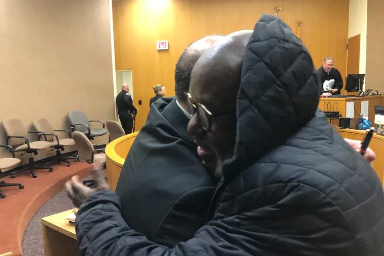 Atlantic City boys basketball coach Gene Allen hugs his attorney William Donio after a judge ordered Allen reinstated as coach for the entire 2018-19 season.