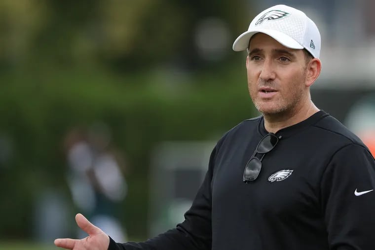 Eagles' GM Howie Roseman talks as he walks across the field at the Philadelphia Eagles training camp at the NovaCare complex in Philadelphia, PA on July 31, 2018. DAVID MAIALETTI / Staff Photographer