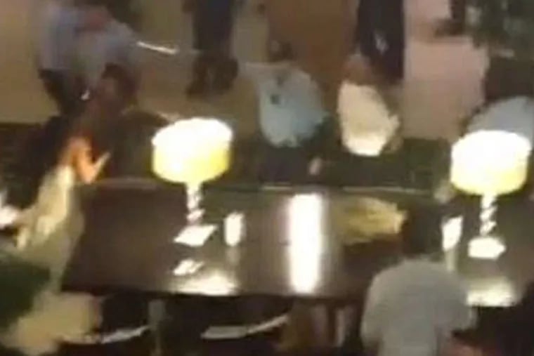 A still image from a video posted to YouTube shows the melee that erupted at the Society Hill Sheraton on Sunday among the attendees of two weddings. Three people were arrested and one man died of a heart attack.