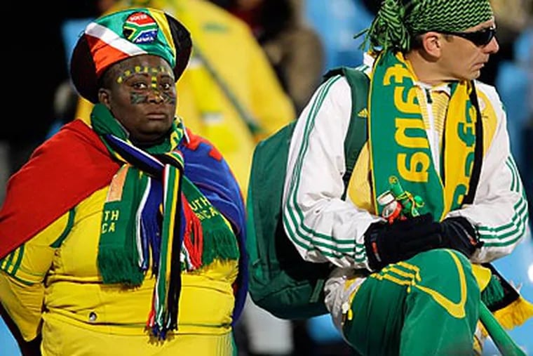 South African fans couldn't hide their sadness after their team lost to Uruguay, 3-0. (Fernando Vergara/AP)