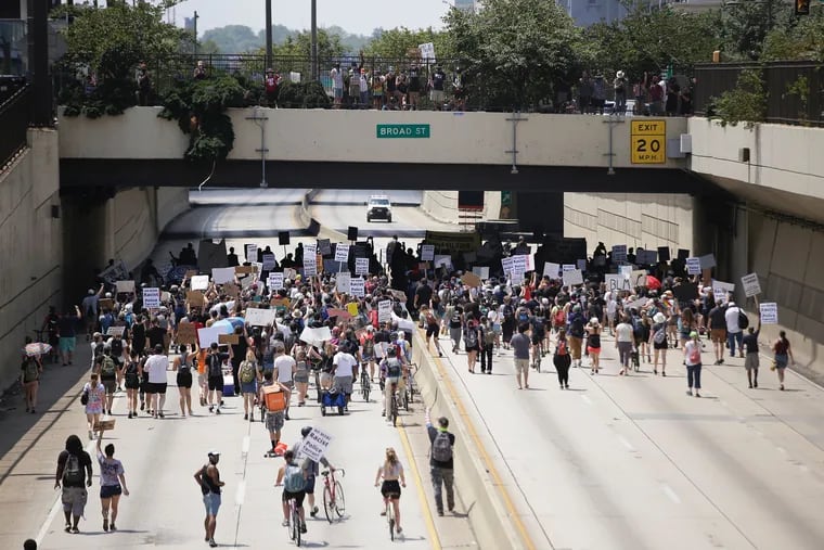 Protesters march on 676 in Philadelphia on Sunday.