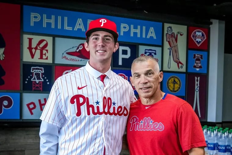 Joe Girardi with Andrew Painter (left) at Painter's signing in July 2021.