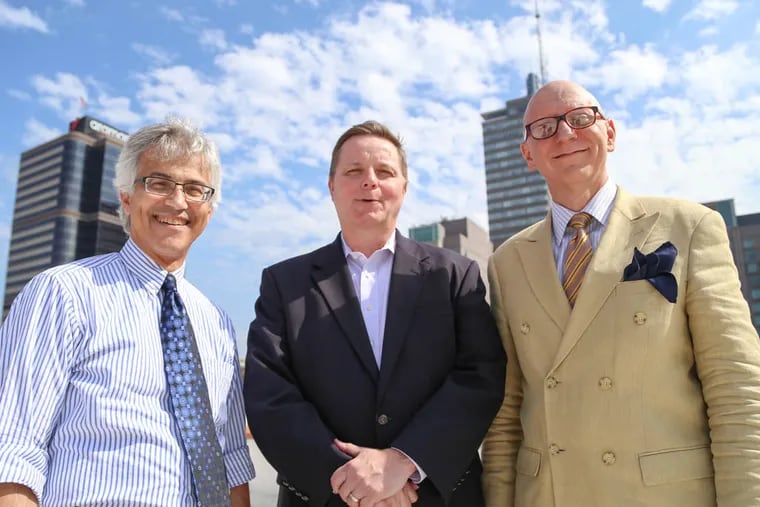 BLT Architects principals Michael L. Prifti, left, Eric M. Rahe, center, and Michael R. Ytterberg, right stand on the roof of their offices at 12th and Arch Street in Center City, Philadelphia on Wednesday, August 6, 2014.  Andrew Thayer / Staff Photographer