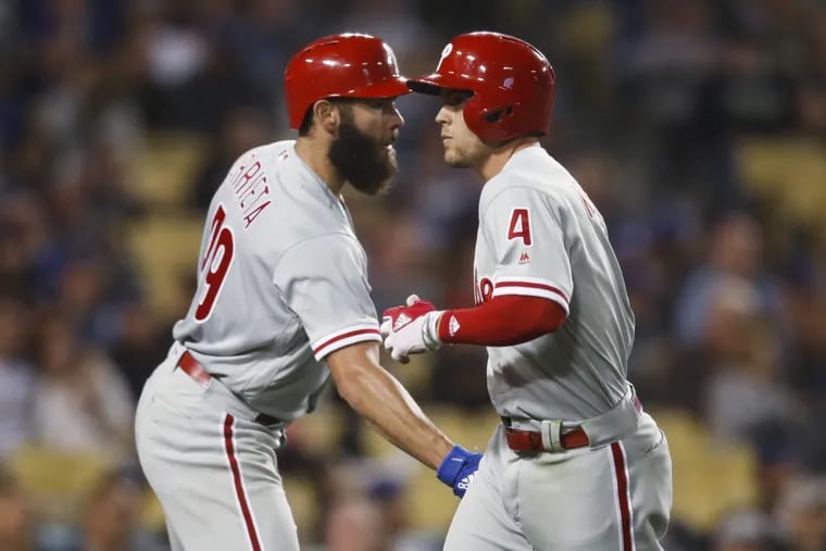 The Phillies' Scott Kingery, right, is greeted by Jake Arrieta after scoring on a double by Jorge Alfaro during the sixth inning Tuesday night.