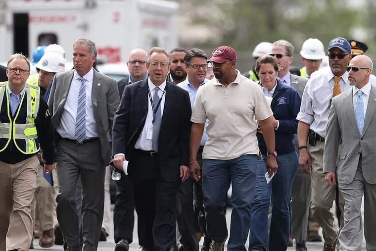 Mayor Nutter walks with officials through the scene of the crash before speaking to the media. (DAVID MAIALETTI / STAFF PHOTOGRAPHER)
