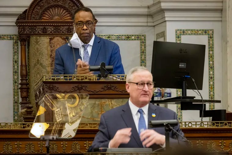 Philadelphia City Council President Darrell L. Clarke (background) applauds as Philadelphia Mayor Jim Kenney gives his budget proposal to City Council in March. Council advanced a budget deal last week that will reduce wage taxes for city residents.