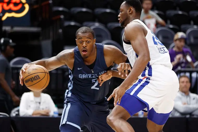 Memphis Grizzlies center Xavier Tillman is guarded by the 76ers' Charles Bassey in Tuesday's summer league game.