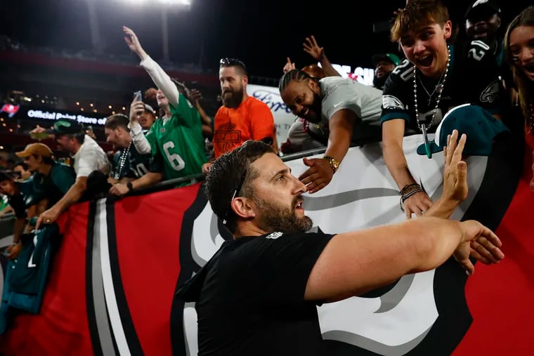Eagles coach Nick Sirianni celebrates his team's win over the Buccaneers with fans in Tampa, Fla., on Monday night.