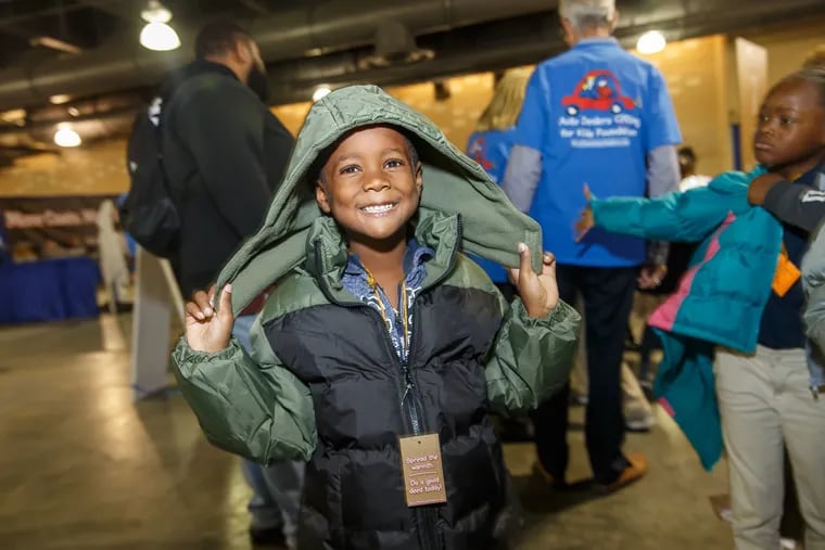 An unidentified Philadelphia School District student beams with excitement after choosing his brand new winter coat during a recent Auto Dealers Caring for Kids Foundation "Driving Away the Cold" event.