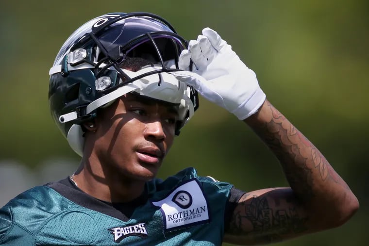 Wide receiver DeVonta Smith (6) puts his helmet back on after drinking water during the Eagles' rookie minicamp at the NovaCare Complex in South Philadelphia on Friday, May 14, 2021.