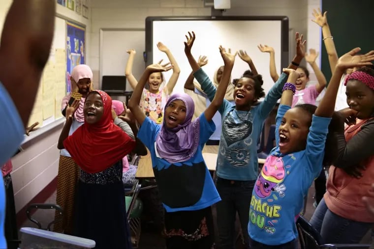 After making a craft, students sing and dance at a Girl Scout activity at Nahed Chapman New American Academy on Thursday, May 18, 2017.