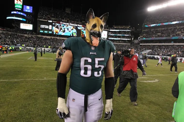 Eagles’ offensive lineman Lane Johnson dons a dog mask and walks off the field after the Eagles defeated the Atlanta Falcons 15-10 to advance to the NFC championship game.