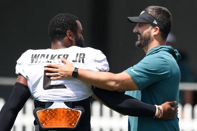 Eagles coach Nick Sirianni hugs Anthony Walker of the Cleveland Browns during a joint practice.
