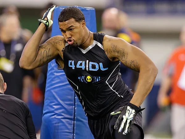 Louisville defensive lineman Marcus Smith, a first-round bust for the Eagles in the 2014 draft, runs a drill at that year's scouting combine. (Michael Conroy/AP)