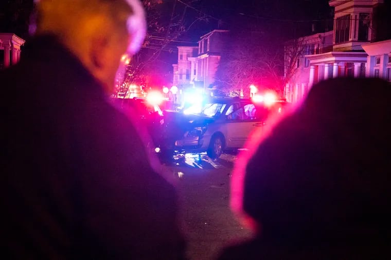 Residents in the area look at the crime scene along Morris Street in Germantown on Tuesday Dec. 3, 2019.