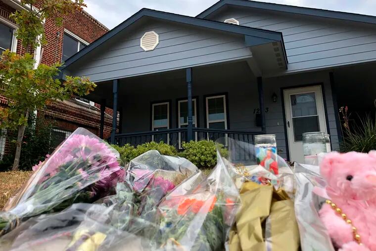 Bouquets of flowers and stuffed animals are piling up outside the Fort Worth home Monday, Oct. 14, 2019, where a 28-year-old black woman was shot to death by a white police officer. Members of the community have brought tributes to the home where Atatiana Jefferson was killed early Saturday by an officer who was responding to a neighbor's report of an open door.