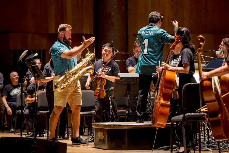 Philadelphia Eagles center Jason Kelce with the Philadelphia Orchestra after playIng "Fly, Eagles, Fly" Tuesday night at the Mann Center.
