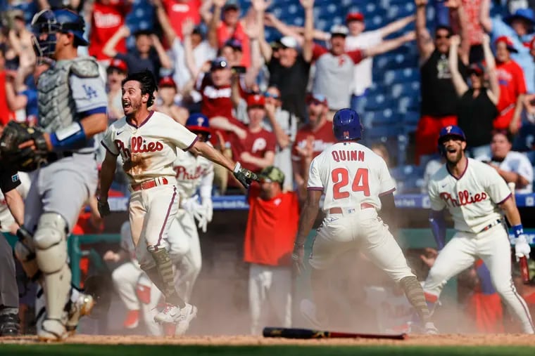 The Phillies' Garrett Stubbs celebrates after teammate Roman Quinn scored the game-winning run in the 10th inning to beat the Dodgers on Sunday.