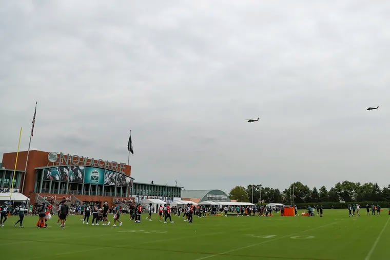 Two Black Hawk military helicopters fly over the field on the first day of training camp open to the public and media at the NovaCare Complex in South Philadelphia on Wednesday.
