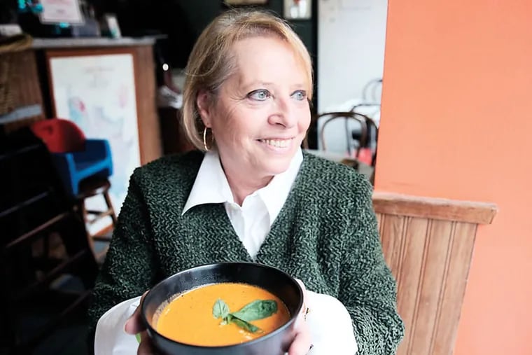 Valerie Blum of Cafe Lutecia holds a bowl of soup at her restaurant in Philadelphia on January 22, 2015.  ( DAVID MAIALETTI / Staff Photographer )