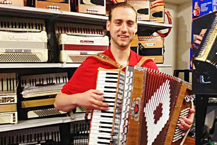 Michael Bulboff, owner of Queen Village accordion shop, with "Baldoni" piano accordion. (Photo: Michael Hinkelman/Daily News Staff)
