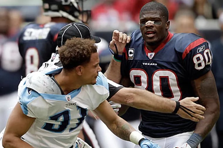 Houston's Andre Johnson (right) was fined, but not suspended, for his fight with Tennessee's Cortland Finnegan. (David J. Phillip/AP)