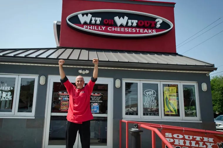 Tony Altomare, owner and operator of “Wit or Witout? cheesesteak shops, strikes the Rocky pose outside his shop at 9970 Roosevelt Blvd. (RON TARVER/Staff Photographer)