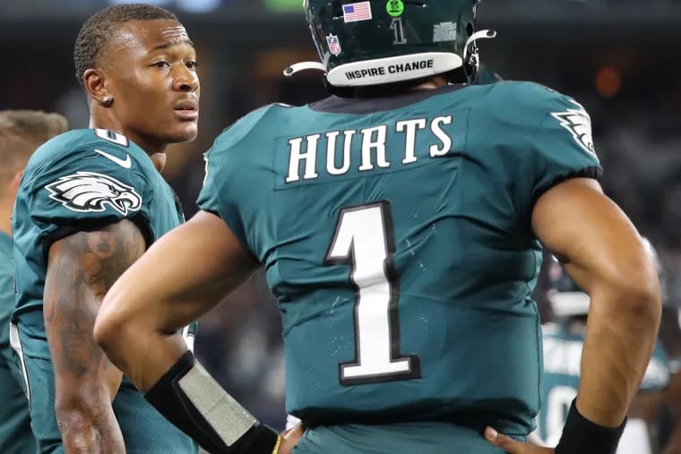 Philadelphia Eagles wide receiver DeVonta Smith (left) talks with Philadelphia Eagles quarterback Jalen Hurts (right) after a pass intended for Smith was intercepted. Philadelphia Eagles lose 41-21 to the Dallas Cowboys at AT&T in Arlington, Texas on September 27, 2021.