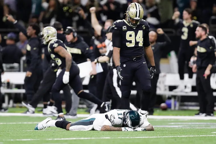 Saints defensive end Cameron Jordan puts out a hand for Eagles wide receiver Alshon Jeffery after the Saints intercepted the football late in the fourth quarter.