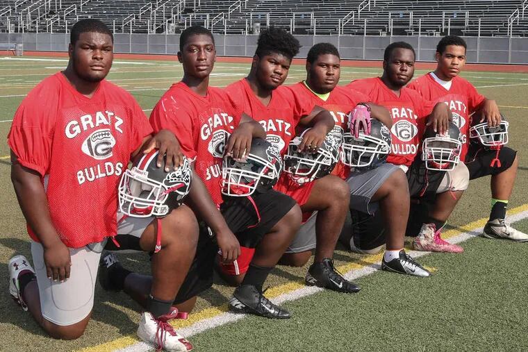 Simon Gratz's offensive linemen (from left) are Raquan Thomas, Charly Timite, Cameron Brown, Amir Baylock and Clifton Mariney. At right is alternate tackle Qadir Ahmed. Gratz, which opens its season Friday evening against Public League Class AAA power Imhotep, reached the league's Class AAAA title game last season. STEVEN M. FALK / Staff Photographer