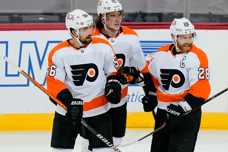 Flyers captain Claude Giroux, right, scored his first goal of the season in the win,