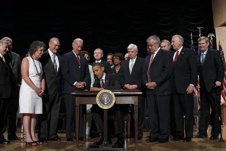 President Barack Obama signs the Dodd Frank-Wall Street Reform and Consumer Protection Act in a ceremony in Washington in July 2010. (AP Photo/Pablo Martinez Monsivais)
