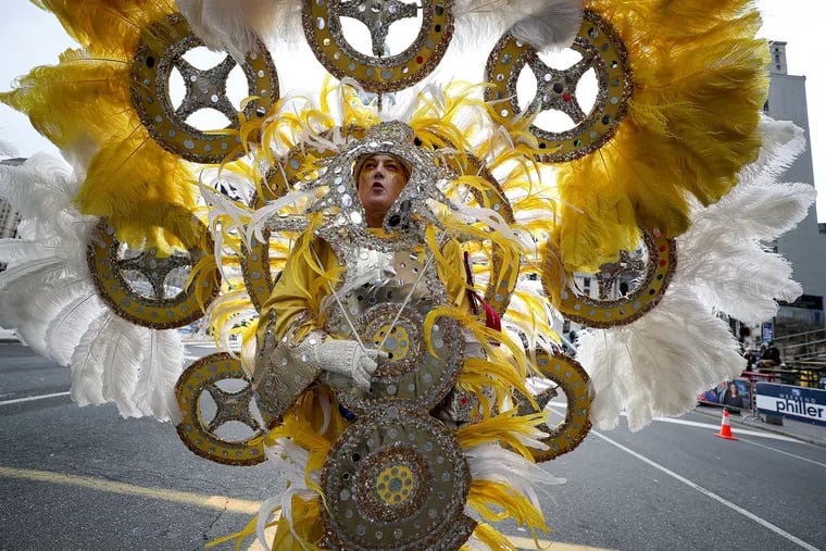 Jennifer Hensell, of Golden Sunrise,  pauses near the judging area during the Mummers Parade in Philadelphia on Jan. 1, 2020.