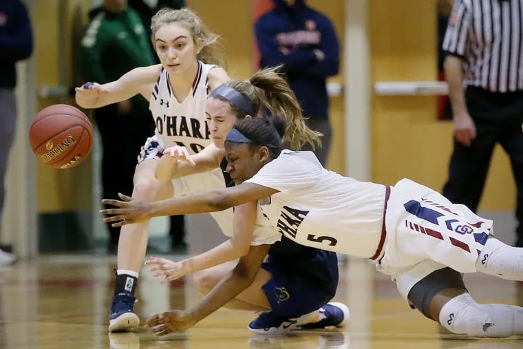 Cardinal O'Hara's Siobhan Boylan (10) and Sydni Scott (5) fight for the ball with Spring-Ford's Cassie Marte (40) during a second-round PIAA Class 6A girls basketball tournament game at Harriton High School.