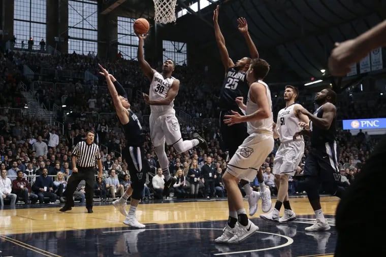 Butler forward Kelan Martin (30) shoots between Villanova defenders Donte DiVincenzo (10) and Mikal Bridges (25) during the first half of the Bulldogs’ upset of the No. 1-ranked Wildcats at Hinkle Fieldhouse.
