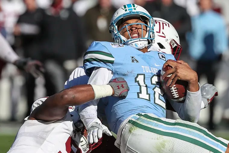 Tulane quarterback Justin McMillan is brought down by Temple defensive end Quincy Roche (9) in the second quarter of a game at Lincoln Financial Field in South Philadelphia on Saturday, Nov. 16, 2019.