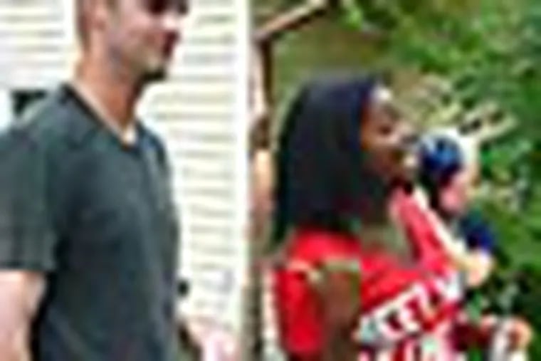 Phillies "super phan" Corinne Hagans introduces her friends and family to starting pitcher Kyle Kendrick. Kendrick stopped by Hagans's Cherry Hill house Saturday morning for a barbecue and room makeover as part of a fan contest. Staff photo by Jonathan Lai