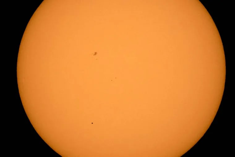 The planet Mercury is seen in silhouette, lower third of image, as it transits across the face of the sun Monday, May 9, 2016, as viewed from Boyertown, Pa.