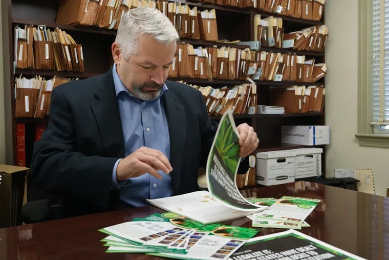 Scott Rudder, president of New Jersey Cannabusiness Association, is shown here with printed materials having to do with the legalization of cannabis, in Haddon Heights, New Jersey, January 4, 2019. JESSICA GRIFFIN / Staff Photographer.