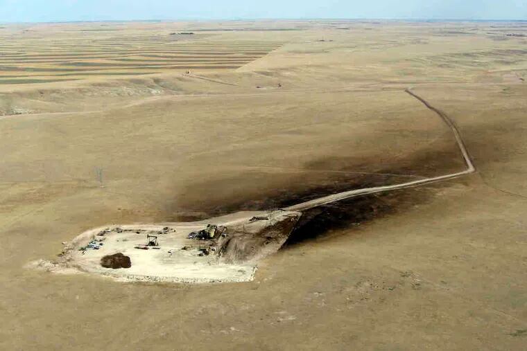 A photo shows oil sprayed downwind of a well east of Cheyenne, Wyo. Using the same method of drilling that opened natural gas reserves in the Marcellus Shale, drillers are reversing a two-decade decline in U.S. production. One concern: Environmentalists fear pollution of drinking water.