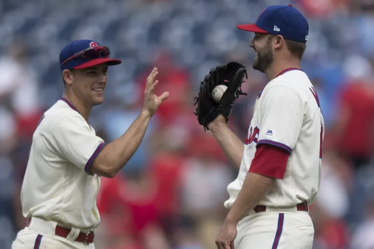 Phillies shortstop Scott Kingery congratulates Adam Morgan Wednesday after the reliever picked up his first career save against the St. Louis Cardinals at Citizens Bank Park.