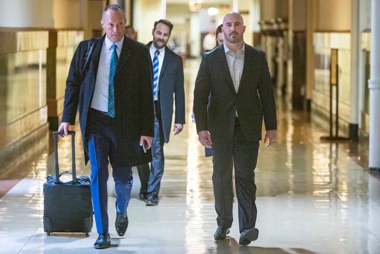 At right is Christopher Maragos, former Philadelphia Eagle arriving at Philadelphia City Hall with attorneys on Monday. Maragos is “suing his doctors for medical malpractice.” At left is attorney Peter J. Flowers.