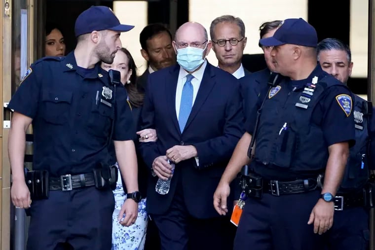 Allen Weisselberg (center) leaves court Thursday in New York.