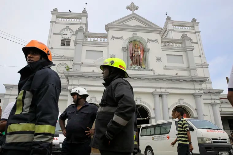 Sri Lankan firefighters stand in the area around St. Anthony's Shrine after a blast in Colombo, Sri Lanka, Sunday, April 21, 2019. Witnesses are reporting two explosions have hit two churches in Sri Lanka on Easter Sunday, causing casualties among worshippers. (AP Photo/Eranga Jayawardena)