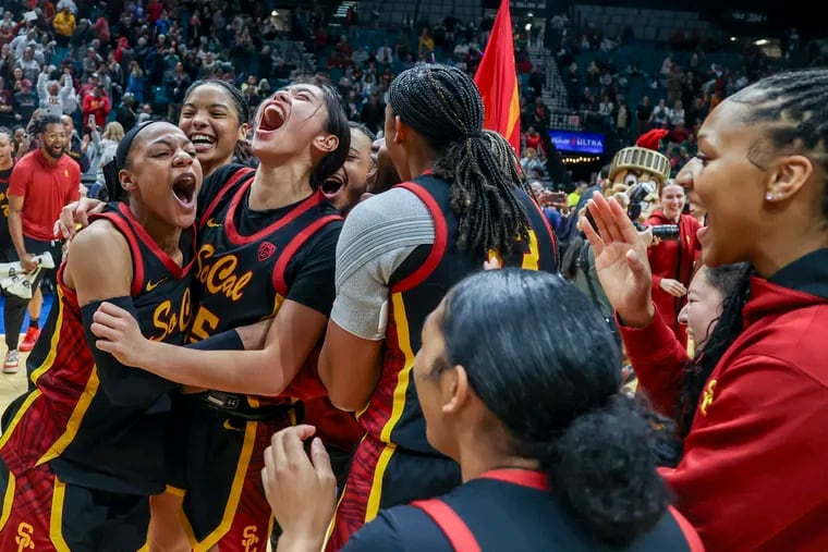 USC's Kayla Williams (left) and Kayla Padilla celebrate with their squad after the Trojans beat Kansas in the second round of the NCAA Tournament. Padilla transferred west after a stellar career at Penn.